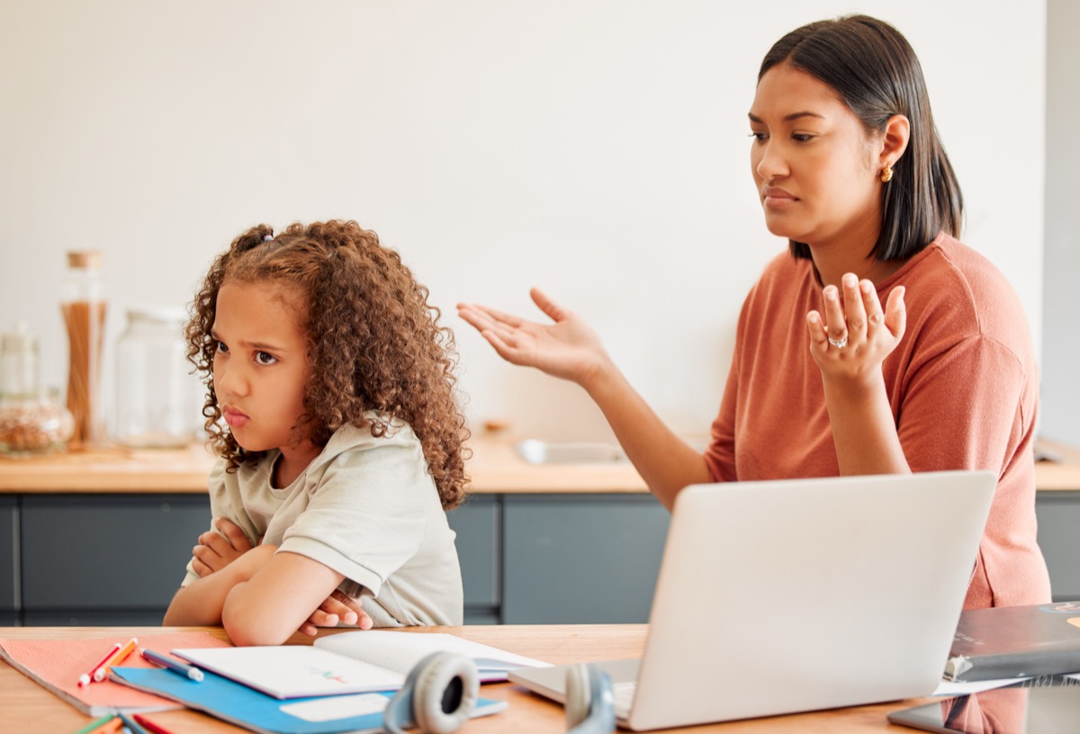 Confused parent teaching upset daughter